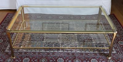 a glass coffee table on a rug in a living room