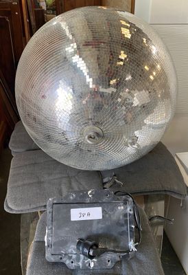 a disco ball sitting on top of a chair in a room