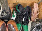 several pairs of shoes are lined up in a wooden box