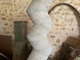 a tall white sculpture sitting on top of a table