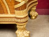 a large wooden cabinet with gold decorations on it
