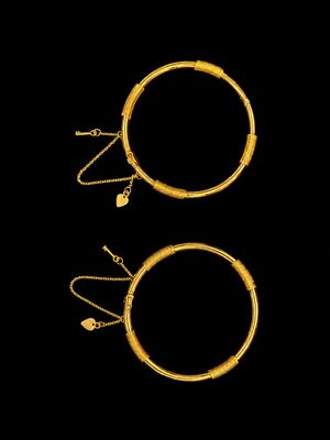 a pair of gold hoop earrings and a pair of gold hoop earrings