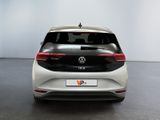 the rear view of a white volkswagen vw golf parked in a room