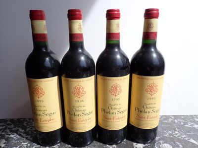 four bottles of wine are lined up on a table