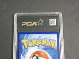 the pokemon card is in a clear plastic holder on a table