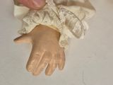 a hand that is holding a cloth with a lace on it