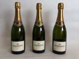 three bottles of champagne sitting next to each other on a table