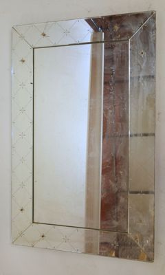 a mirror hanging on the wall in a bathroom