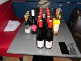 many bottles of wine sitting on a table in a booth