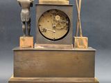 a clock that is sitting on top of a wooden stand
