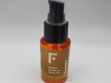 a close up of a bottle of liquid on a white surface