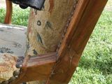 a cat that is sitting on a chair in the grass