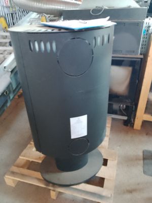 a black trash can sitting on a pallet in a warehouse