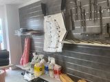 a picture of a kitchen with a lot of utensils hanging on the wall