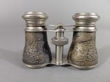a pair of silver binoculars that are sitting on a table