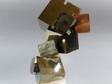 a sculpture made out of metal blocks on a white surface