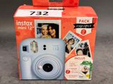 un appareil photo Instax Mini bleu dans la boîte