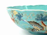 a blue bowl with a bird and fish design on it