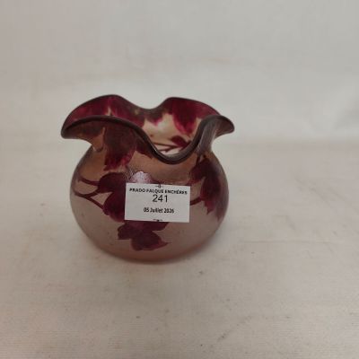 a glass vase with a red flower inside of it