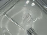 a close up of a glass container with a metal handle