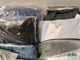 a suitcase full of clothes sitting on a table