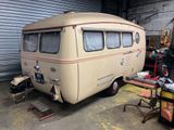 a small bus that is parked in a garage