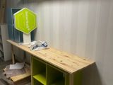 a wooden shelf with a green shelf on top of it