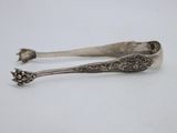 two spoons that are sitting on a table
