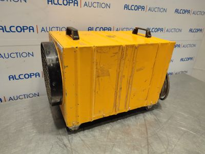 a yellow box sitting on top of a dolly in front of a wall