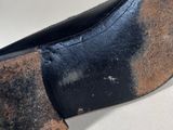 the bottom of a pair of black shoes on a white surface