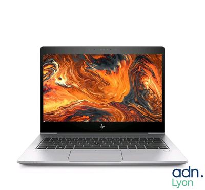 an open laptop computer sitting on top of a white surface