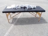 an image of a black massage table in a parking lot