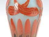 a glass vase with an orange and blue design on it
