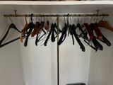 a closet with several pairs of shoes hanging on a rack