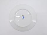 a white plate with a blue flower on it