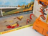 an orange toy truck and a box of construction toys
