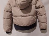 an image of a jacket hanging on a hanger on a wall