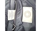 a close up of a black jacket with a label on it