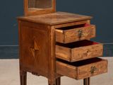 an old wooden dresser with three drawers and a mirror on top of it