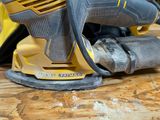 a corded sander sitting on a wooden table
