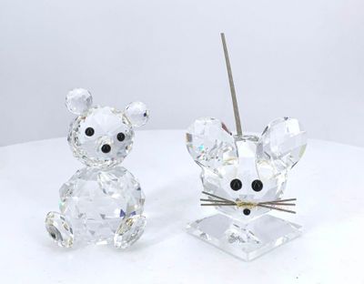 crystal figurines of a mouse and a cat on a white surface