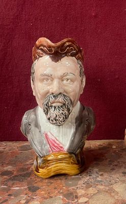 two ceramic figurines of a man and a woman on a table