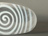 a close up of a glass object with a spiral design on it