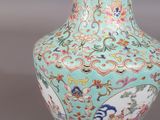 an image of a blue vase with flowers and birds on it