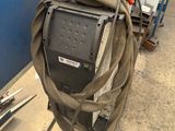 a hose attached to the back of a machine in a garage