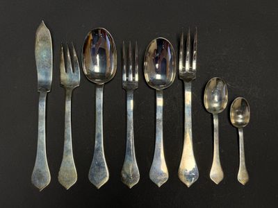 five spoons, two forks, and two spoons on a table