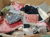 a cardboard box filled with clothing and other items