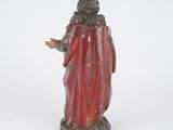 figurine of a man with a red robe and a red cloak