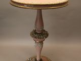 an image of a table with a pink base and gold trim