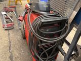 a machine that is sitting on the ground next to some tools